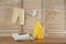 Fresh baby towel, toy and bottle of detergent on wooden table