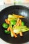 Fresh baby vegetables being sauteed