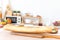 Fresh baguette bread on wooden cutting board with blur cozy kitchen background. Bread and jam for making breakfast in morning.