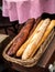 Fresh baguettes bread in a basket. Many baguettes