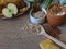 Fresh and baked apples, shortbread biscuits, oats in an wooden spoon, yogurt and cinnamon sticks on rustic style oak background.