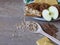 Fresh and baked apples, shortbread biscuits, oats in an wooden spoon, yogurt and cinnamon sticks on rustic style oak background.