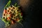 Fresh baked Belgian waffles with arugula, tomatoes and avocado on black a plate. Savory waffles. Breakfast concept. Healthy