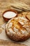 Fresh baked bread with wheat ears and a bowl of flour