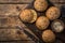 Fresh baked buns with sesame, sunflower and flaxseed, wooden background