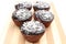 Fresh baked chocolate muffin with desiccated coconut on chopping board