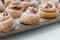 Fresh baked cinnamon rolls on steel baking tray. Homemade cinnamon buns for breakfast