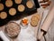 Fresh baked cookies on baking tray. Dough roll and scattered flour.