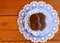 Fresh baked cookies on lavender plate with white doilies on a wood table