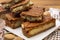 Fresh baked Dutch filled spicy cookies with almonds in autumn colors on dark wooden background