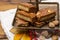 Fresh baked Dutch filled spicy cookies with almonds in autumn colors on dark wooden background