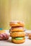 Fresh baked homemade colorful donuts on light wooden