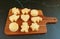 Fresh Baked Homemade Cookies on Wooden Breadboard Isolated on Black Mable Table