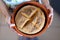 Fresh baked irish soda bread with cutted cross holding by hands of a little girl. Healthy, home made, delicious meal