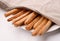 Fresh baked Italian grissini breadsticks covered with cloth