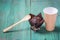 Fresh baked muffins, paper cup coffee and a spoon on a wooden green table for the holiday