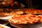 Fresh-baked pizzas on pizzeria restaurant counter