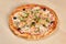 Fresh baked seafood pizza on wooden background