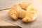 Fresh baked tasty croissants on brown napkin