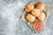 Fresh baked yeast buns filled with apple jam on gray background with flour