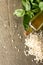 Fresh basil leaves, rice arborio and olive oil on rustic background