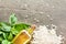 Fresh basil leaves, rice arborio and olive oil on rustic background