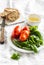 Fresh Basil, tomatoes on a white plate, olive oil and a baguette