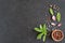 Fresh bay leaf, allspice, pink peppercorn, garlic on dark stone background