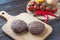 Fresh beaf burgers on cutting board with tomato, pepper and onion.