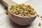 fresh bee pollen granules in wooden spoon