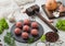 Fresh beef meatballs on stone board with pepper, salt and garlic on light background with dill,parsley and dill and onion and