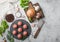 Fresh beef meatballs on stone board with pepper, salt and garlic on light background with dill,parsley and dill and onion