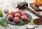 Fresh beef meatballs on stone board with pepper, salt and garlic on light background with dill,parsley and dill and onion and