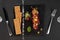 Fresh beef tartar with salt and herbs and Crispbread, studio shot. Meat tartar on black shale. On white background