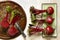 Fresh beetroots on green ceramic tray and metal plate