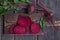 Fresh beetroots with leaves on wood table.Whole and cut beetroots