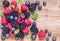 Fresh berries, blueberry, raspberry, blackberry on rustic wood background