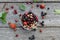 Fresh berries of cherry, gooseberry, currant lie on a glass plate and scattered around it