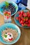 Fresh berries drink and muesli on wooden table.