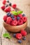 Fresh berries raspberry blueberry in wooden bowl