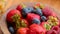 Fresh berries , strawberries, raspberries, blueberries in a copper bowl