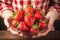 Fresh berry bounty Womans hands hold a bowl of strawberries