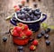 Fresh berry fruits in a enameled pots