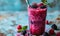 Fresh Berry Smoothie in a Tall Glass with a Striped Straw, Vibrant Purple Drink Accompanied by Blackberries on a Light Blue