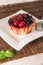 Fresh berry tartlet or cake filled with custard, raspberry, blueberry redcurrant and blackberry delicious dessert, easy diet. Clos