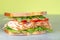 Fresh big sandwich. Turkey ham on a white bread with lettuce, tomatoes and cheese. Food background