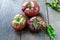 Fresh Black Brandywine Organic Tomatoes and basil on a wooden table.