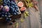 Fresh Black Grapes and Figs in Dark Wooden Tray on Wooden Table