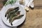 Fresh black tiger shrimps on a plate on a rustic wooden board, g