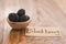 Fresh blackberries in wood bowl on wooden table with paper card